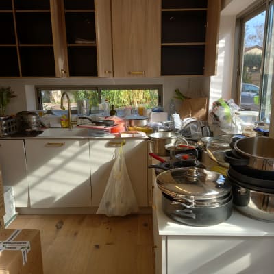 מטבח עם כלים וסירים על השיש, ארונות פתוחים