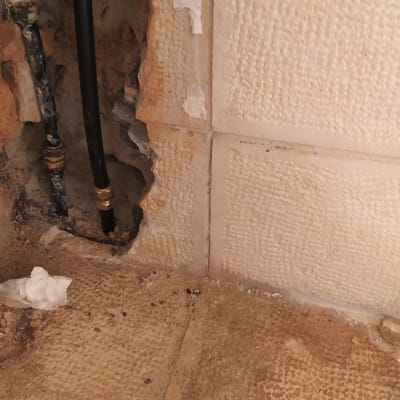 צינורות מים בקיר עם חיבורי מתכת