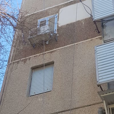 יחידת מיזוג אוויר מותקנת על קיר חיצוני של בניין