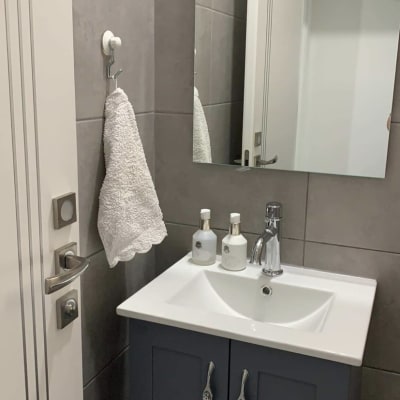Bathroom sink with faucet and mirror above
