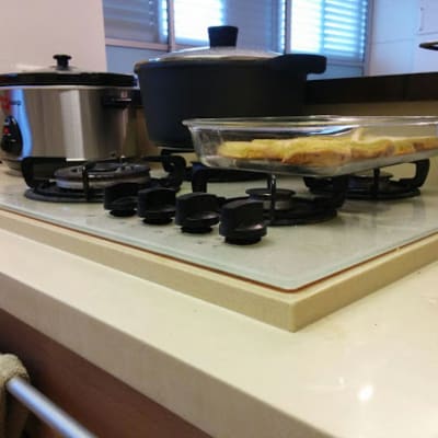 A kitchen countertop with a gas stove and cooking utensils.