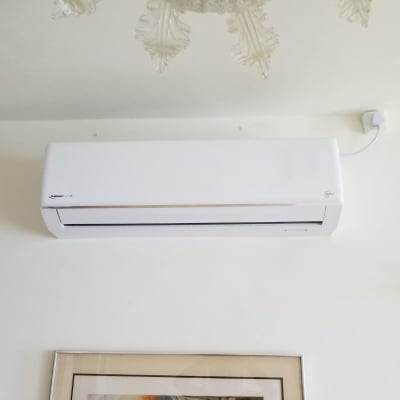 מזגן קיר לבן מותקן על קיר פנימי