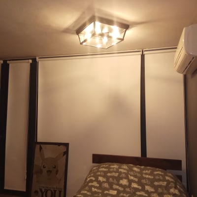 מנורת תקרה דולקת בחדר עם מזגן על הקיר