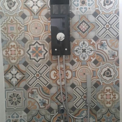 ראש מקלחת מרובע עם צינור מתכת על קיר מעוצב