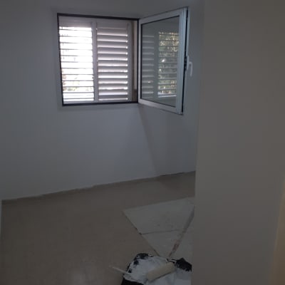 רולר צביעה ומגש צבע על רצפה בחדר