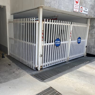 שני מברגות ומטר על רצפה ליד שער מתכת