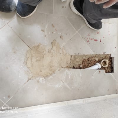 צינור מים חשוף ברצפה עם חול מסביב