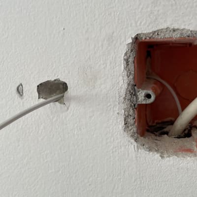 כבל רשת יוצא מקיר לתוך תיבה כתומה