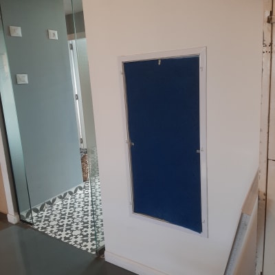 פתח אוורור כחול בקיר לבן