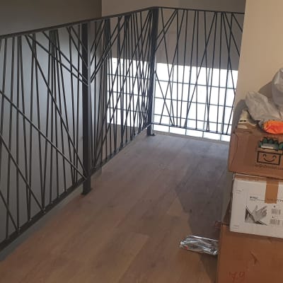 מעקה מתכת עם עיצוב גיאומטרי לאורך מסדרון