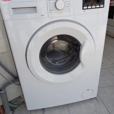 מכונת כביסה לבנה עם פאנל שליטה דיגיטלי