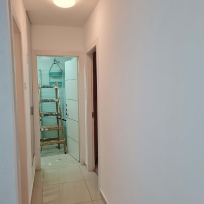 סולם עץ בחדר עם קירות צבועים בלבן