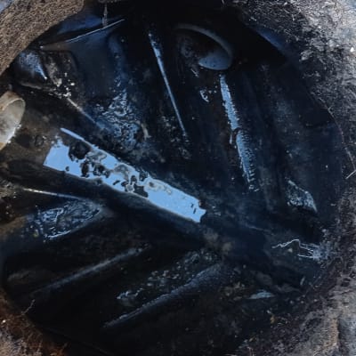 פתח ביוב עם צינור פלסטיק ומים עומדים