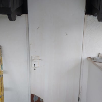 דלת לבנה עם קילופי צבע בתחתית