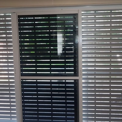 תריסי אלומיניום על חלון זכוכית גדול