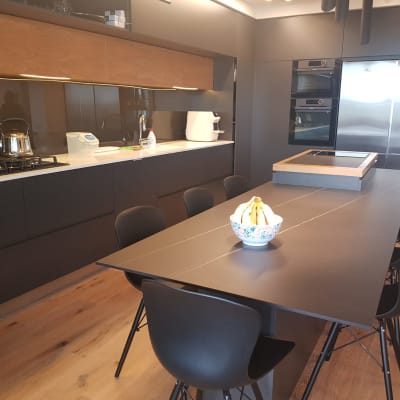 מטבח מודרני עם שולחן ארוך, כיסאות ותנור