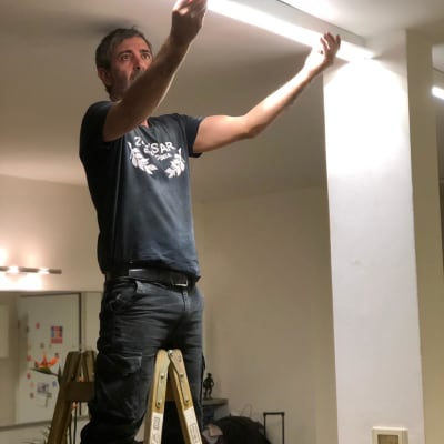 Electrician working on ceiling light fixture