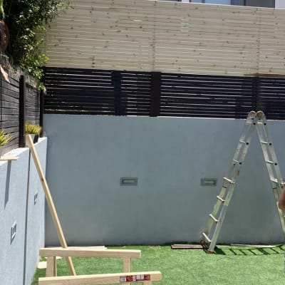 מסגרת עץ על דשא מלאכותי עם סולם ברקע