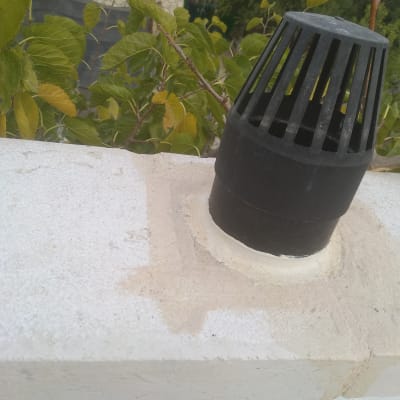 צינור שחור אטום על גג לבן