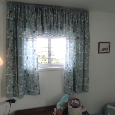 וילון תלוי על חלון עם תריסים