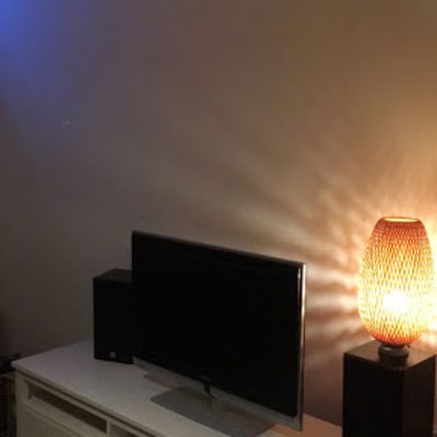 טלוויזיה על שידה עם מנורה דולקת