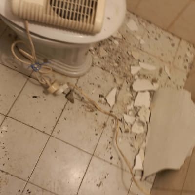 שברים של קיר על רצפה עם חוט חשמל