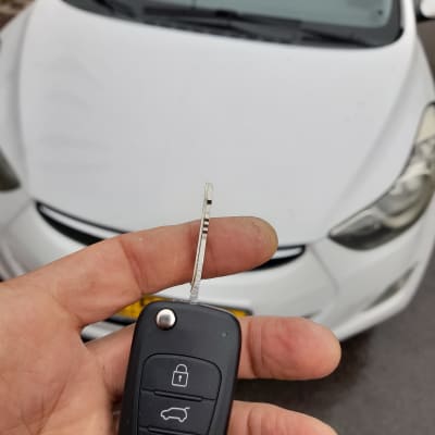 מפתח רכב מול מכונית לבנה