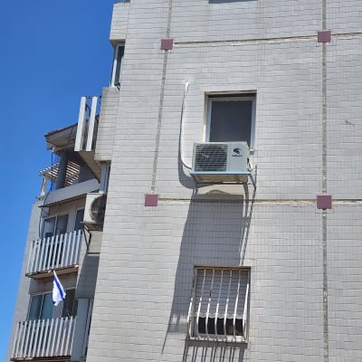 יחידת מזגן חיצונית מותקנת על קיר בניין