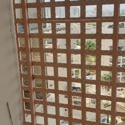 רשת מתכת על חלון למניעת כניסת יונים