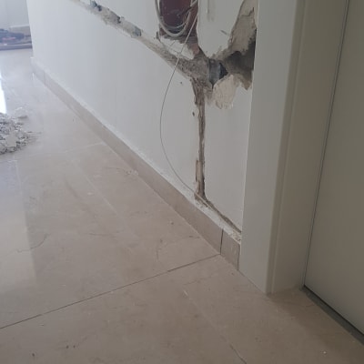 קיר עם חציבה ותעלות חשמל חשופות