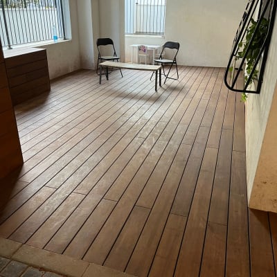 רצפת עץ עם שני כיסאות מתקפלים ושולחן קטן