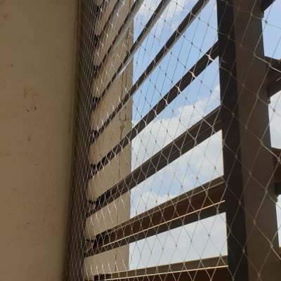 רשת מתכת מותקנת על חלון למניעת כניסת יונים