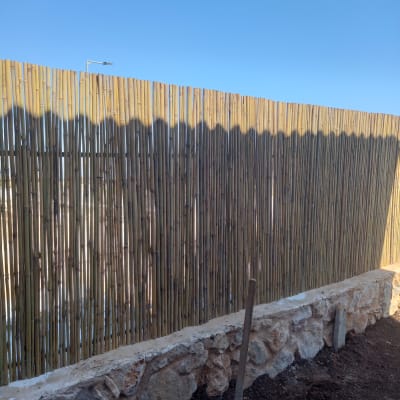 את חפירה תקועה באדמה ליד גדר במבוק