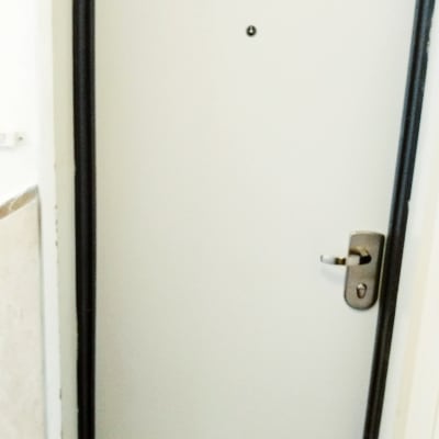 דלת עם ציפוי לבן וידית מתכת כסופה