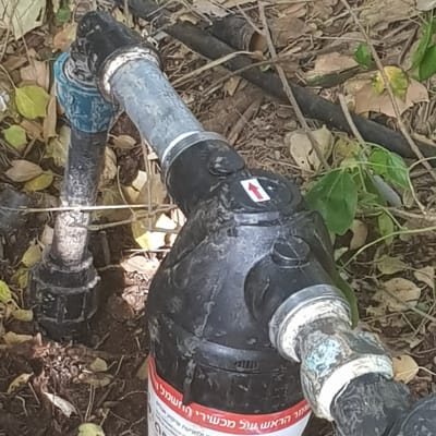 צנרת מים עם מסנן ומחברים בשטח פתוח