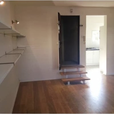 חדר עם מדפים ריקים ותאורה, רצפת עץ חדשה