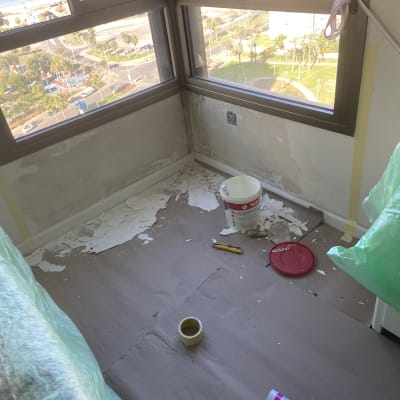 חדר בשיפוץ עם קירות מתקלפים, דלי צבע וכלי עבודה