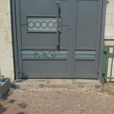 שער מתכת אפור עם עיטורים גיאומטריים