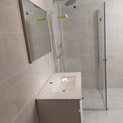 חדר אמבטיה משופץ עם מקלחון וכיור חדש