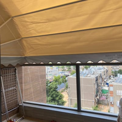 סוכך בד צהוב מותקן מעל מרפסת