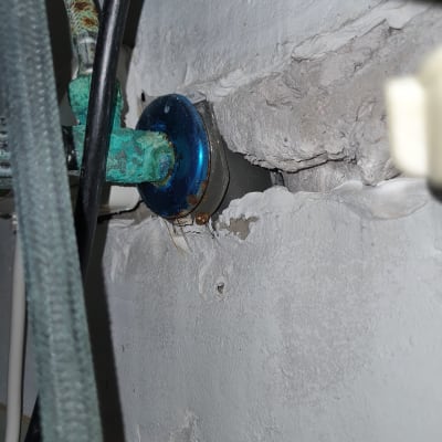 צינור חלוד עם חיבור לקיר