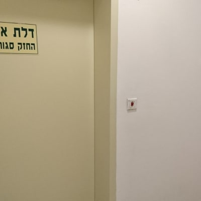 קיר צבוע בלבן עם דלת בצבע קרם