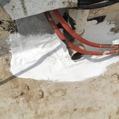 איטום עם חומר לבן סביב צינורות וקיר