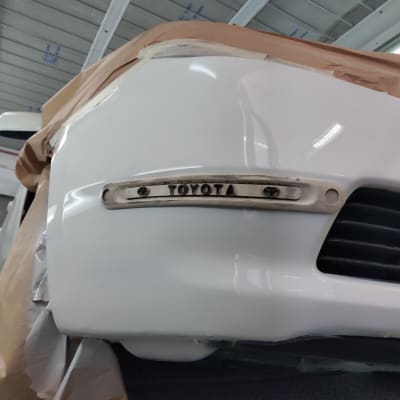 חלק קדמי של רכב בתהליך צביעה עם נייר מגן