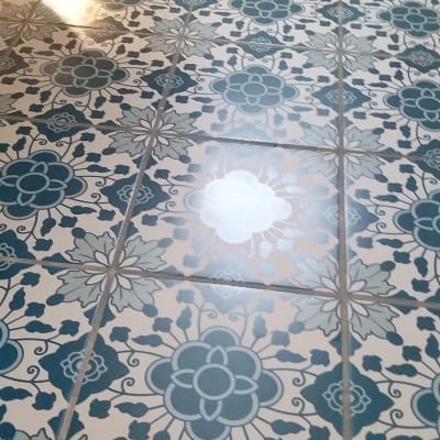 רצפה נקייה עם אריחים מעוטרים בפרחים כחולים