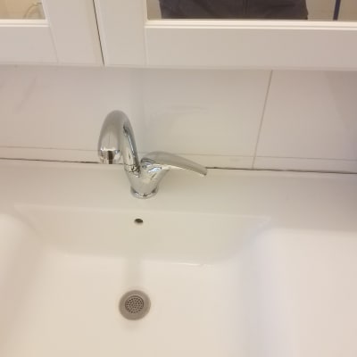 ברז כרום מעל כיור לבן בחדר אמבטיה