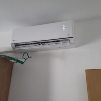 מזגן קיר לבן עם תצוגת טמפרטורה דולקת