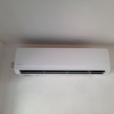 יחידת מיזוג אוויר מותקנת על קיר לבן