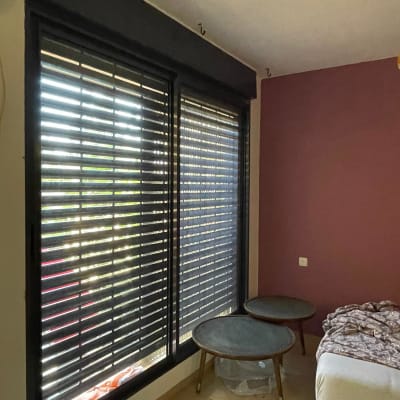 תריסי אלומיניום שחורים בחלון גדול