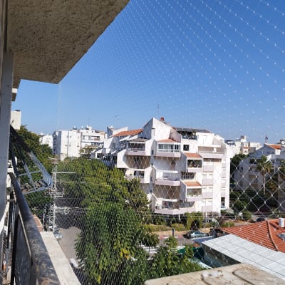 רשת הגנה נגד יונים מותקנת במרפסת בניין